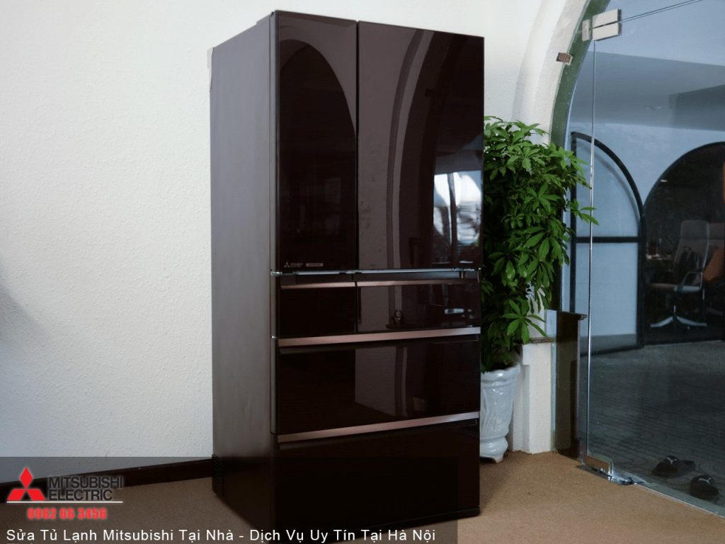Mitsubishi Electric black refrigerator in modern kitchen setting with potted plant, Reflective surfaces, energy-efficient cooling appliance, and sleek design for home appliance SEO.