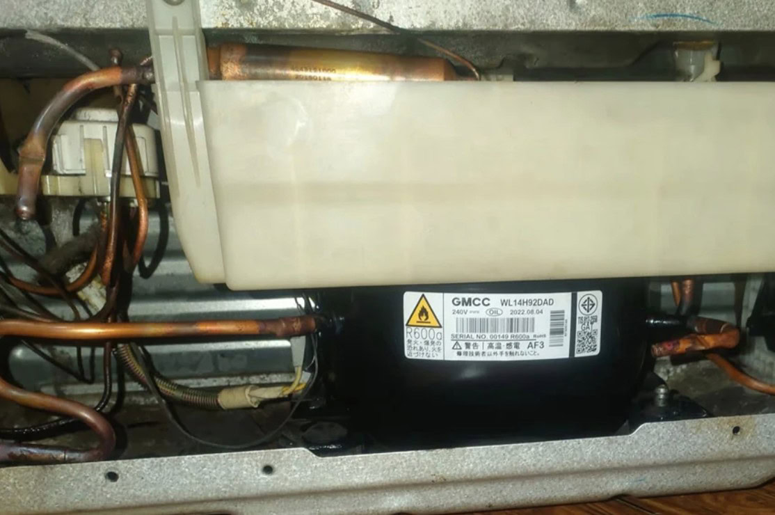 High-efficiency Mitsubishi HVAC compressor with copper tubing and electrical wiring, essential for reliable air conditioning system operation.